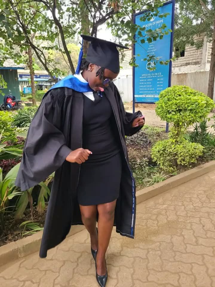 A young woman celebrating her graduation in cap and gown