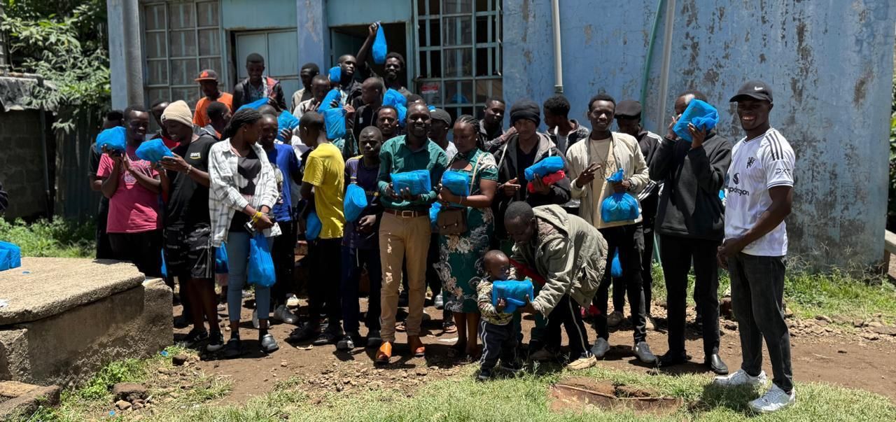 Community members holding their food parcels
