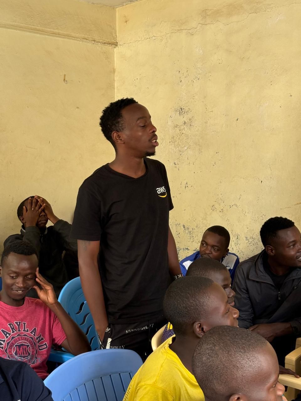 A young man stands to share his story