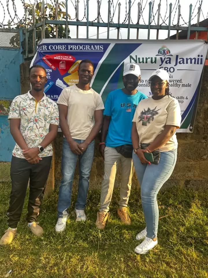 Volunteers in front of the Nuru ya Jamii banner